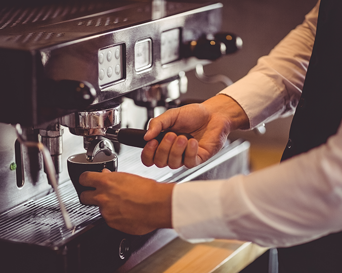 waiter-using-coffee-machine-in-cafeteria